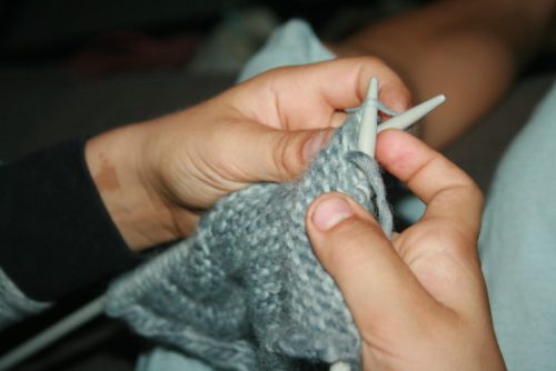 les mains de l'apprenti tricoteur